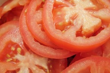 Sliced tomatoes may be eating with or without salad dressings.